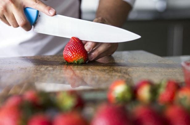  Cutting a strawberry in half 