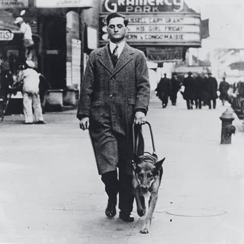 Image of Morris Frank walking with his dog Buddy